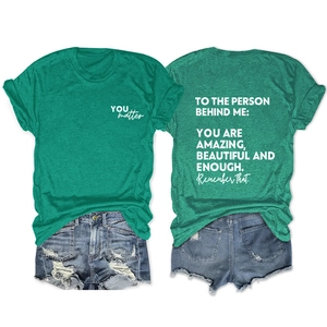 Flat lay of green cotton T-shirt with YOU matter print and distressed denim shorts