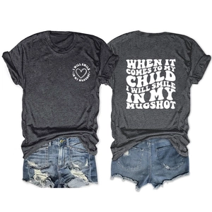 Deep grey t-shirt with heart print and distressed blue denim shorts flat lay set