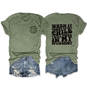 Detail showing the 'I WILL SMILE IN MY MUGSHOT' slogan print on an olive green T-shirt