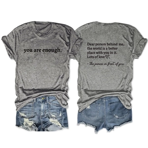 Detail of grey crewneck T-shirt with 'you are enough' print and distressed denim shorts