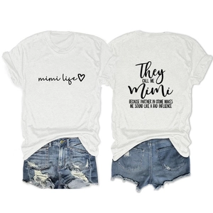 Detail view of white Mimi Life t-shirt with back print and ripped denim shorts