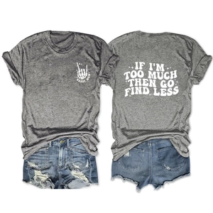 Flat lay of gray Sassy Mom tee with 'Go Find Less' back print and ripped denim shorts