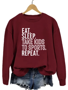 Détail de l'imprimé Eat Sleep Take Kids sur un sweat-shirt à col rond bordeaux
