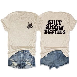 Flat lay view of cotton t-shirt with Shit Show Besties print and ripped denim shorts