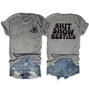 Flat lay of gray cotton T-shirt with Shit Show Besties print and ripped denim shorts