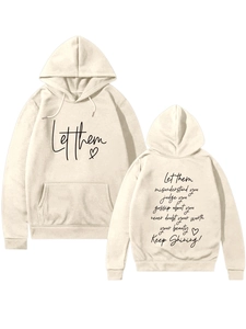 Detail showing the 'Let them' heart print and motivational text on the beige hoodie