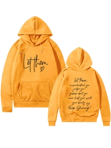 Detail view of ginger yellow hoodie featuring Let Them heart print and back quote