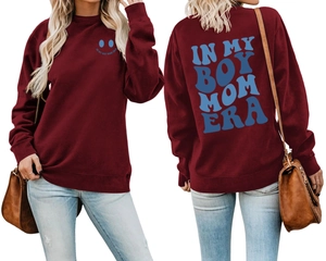 Detail of burgundy boy mom era sweatshirt featuring blue puff print and ribbed cuffs