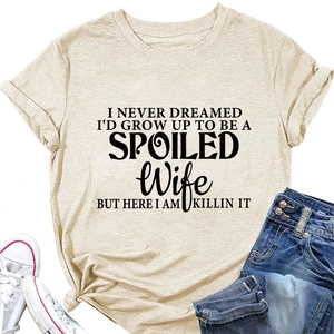 Close-up of beige t-shirt featuring black spoiled wife letter print and cotton fabric
