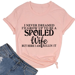 Detail of pink t-shirt with black letter print and stylish side knot design