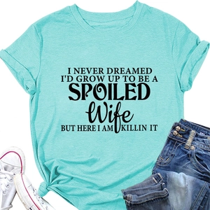 Flat lay of Tiffany blue t-shirt with black typography paired with denim jeans and shoes