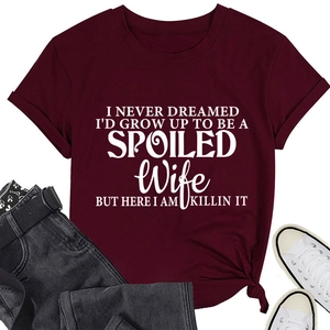 Detail of burgundy T-shirt showing I Never Dreamed I'd Grow Up print and knotted hem