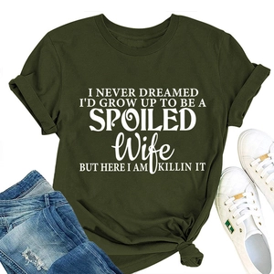 Flat lay of army green graphic t-shirt styled with ripped jeans and sneakers