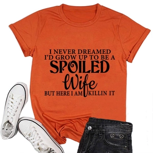 Close-up of orange cotton T-shirt with black letter print paired with denim shorts