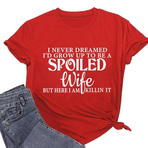 Detail of red crew neck t-shirt with white letter print and stylish front knot hem