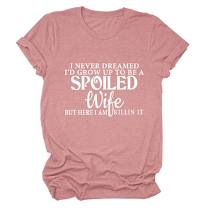 Close-up of pink round neck T-shirt with white slogan print on a clean white background