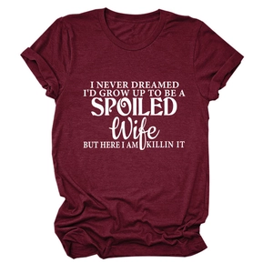 Detail of burgundy crew neck T-shirt with white 'SPOILED Wife' quote and rolled sleeves