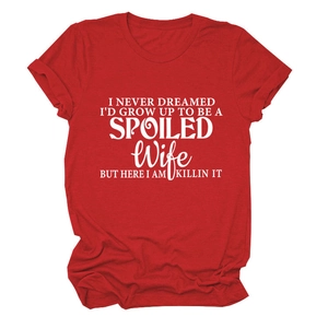 Close-up of artistic white letter printing on a bright red crew neck cotton T-shirt