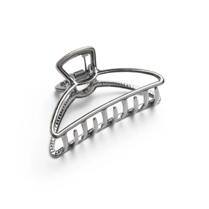 Macro view of gunmetal alloy crescent hair claw clip showing polished teeth and spring