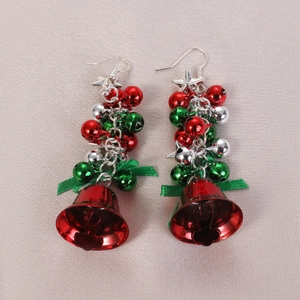 Christmas star and colorful bell drop earrings with green ribbon bow on textured fabric