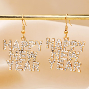 Macro detail of gold-plated Happy New Year earrings with sparkling rhinestones and French hooks