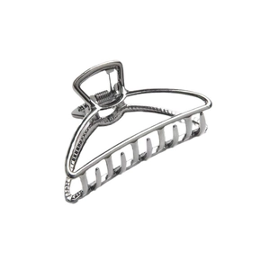 Polished silver half-moon metal hair claw clip with cutout triangle design on white background