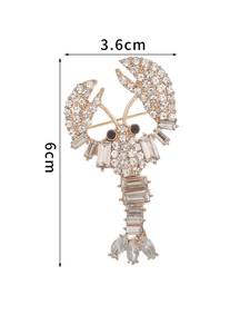 Detailed view of luxury lobster brooch with clear rhinestones and golden alloy finish