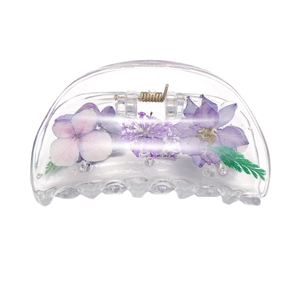Minimalist transparent hair claw clip with embedded purple dried flowers and green leaves