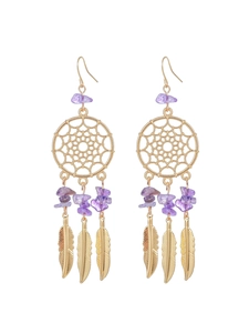 Detail view of golden dreamcatcher earrings featuring purple stones and metal feathers
