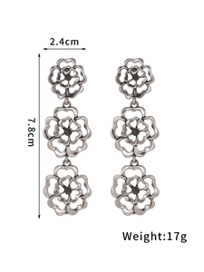Detailed view of vintage silver hollow flower drop earrings with size measurements