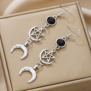 Vintage silver star and moon drop earrings with black beads on gold textured background