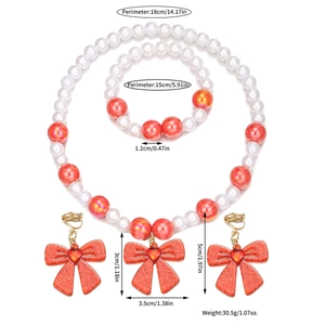 Detail view of pearl jewelry set with red heart bow pendants and size specifications