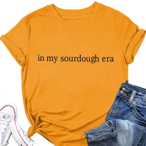 Detail of ginger yellow cotton t-shirt featuring in my sourdough era slogan print