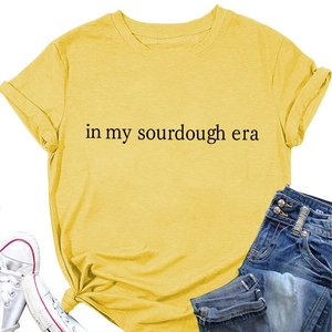 Flat lay of yellow t-shirt with in my sourdough era print with jeans and sneakers