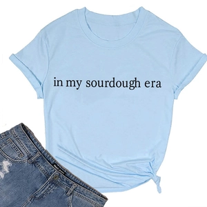 Detail of light blue cotton T-shirt featuring In My Sourdough Era print and side knot
