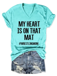 Detail of turquoise V-neck T-shirt with My Heart Is On That Mat print and denim shorts