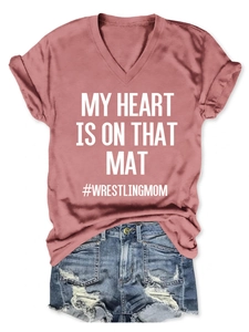 Detail of V-neck rose pink T-shirt with MY HEART IS ON THAT MAT printed slogan