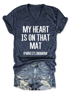 Detail of V-neck T-shirt with My Heart Is On That Mat wrestling mom text and denim shorts