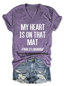 Detail view of purple V-neck wrestling mom t-shirt and distressed denim shorts outfit set
