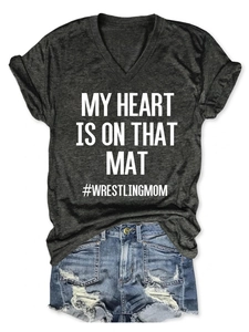 Detail of V-neck T-shirt with 'My Heart Is On That Mat' text and ripped denim shorts