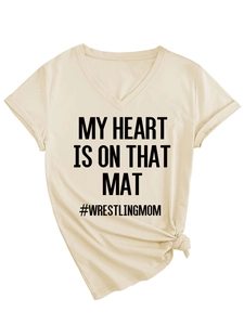 Detail of V-neck beige T-shirt with MY HEART IS ON THAT MAT print and knotted hem