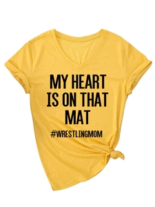 Detail of yellow V-neck T-shirt with rolled sleeves, side knot and wrestling slogan