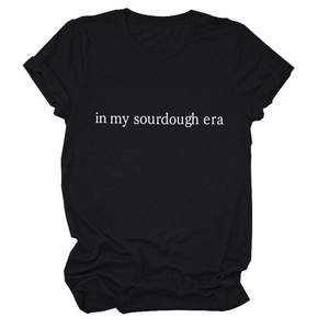 Close-up of black cotton T-shirt featuring white in my sourdough era slogan print