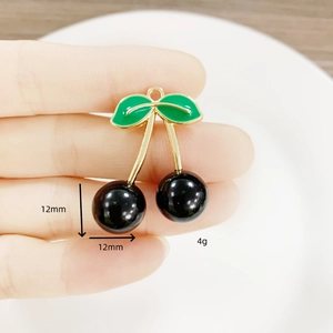 DIY cherry fruit pendant with green leaves and black spheres for jewelry making