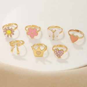 7-piece colorful enamel and rhinestone adjustable ring set for girls featuring crowns and bows