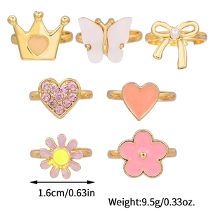 Adjustable kids ring set featuring gold crowns, bows, and flowers with pink enamel