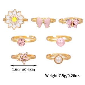 Set of 7 gold children's open rings featuring daisies, bows, butterflies and stars