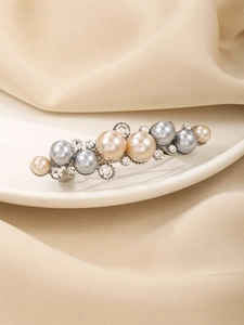 Detailed shot of hair clip with blue and champagne pearls and crystals on silver base