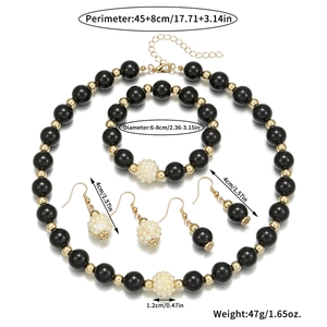Elegant black beaded necklace bracelet and earring set with golden spacers and star patterns