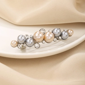 Elegant metal spring hair clip featuring champagne pearls and sparkling rhinestones